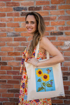 Sunflower tote bag with light blue background.