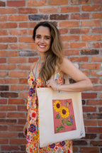 Sunflower tote bag with coral background.