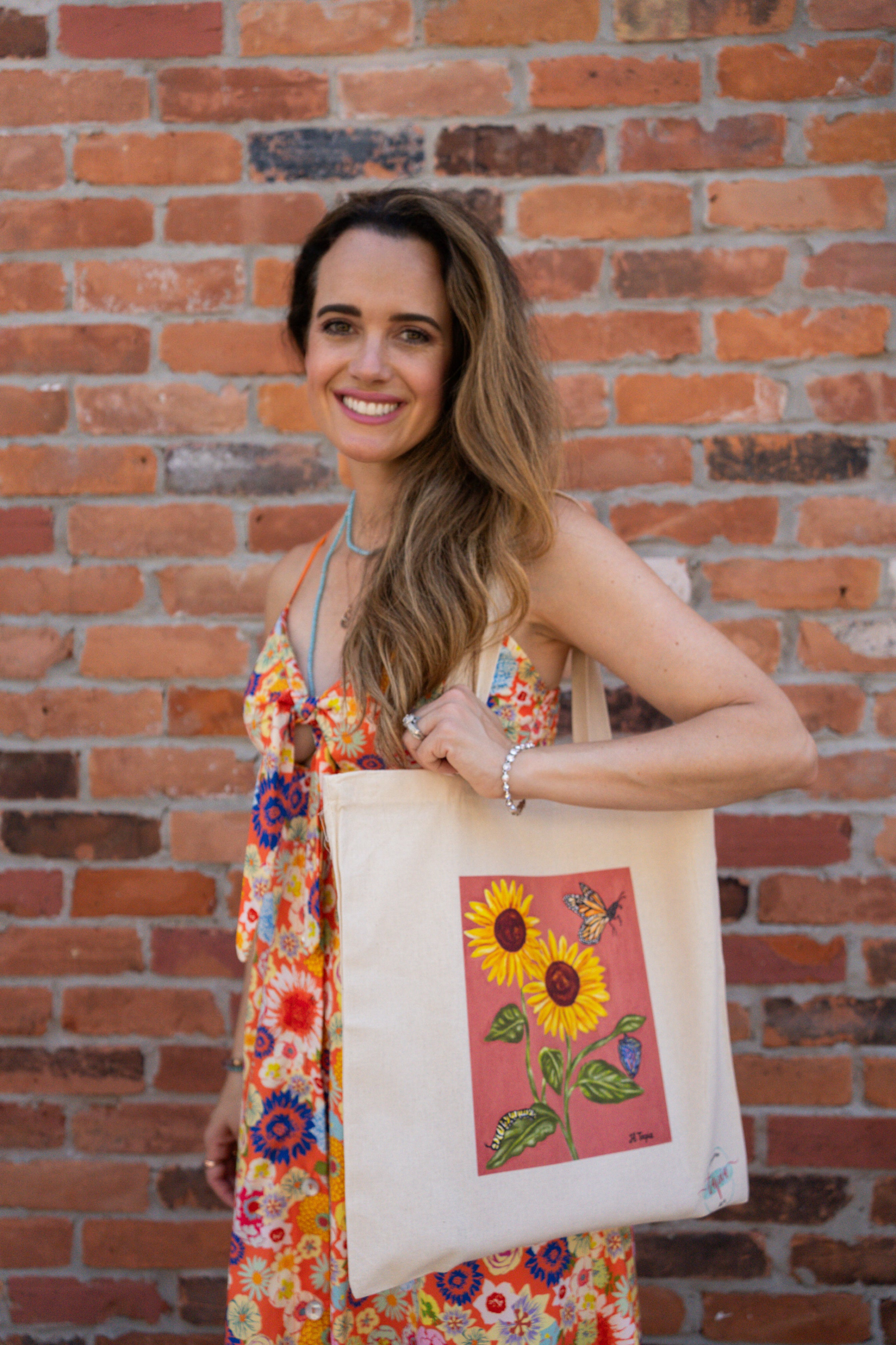 Sunflower tote bag with coral background.